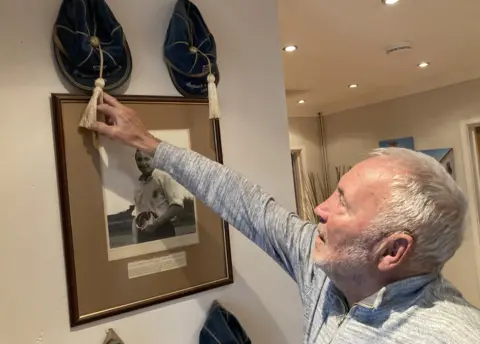 Barry Bridges looking at his England caps