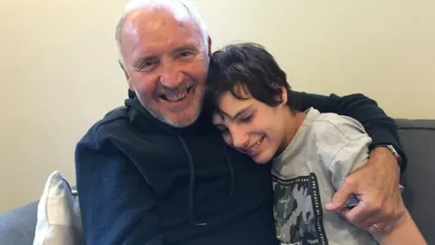 Precey family Barry Bridges smiling with a teenage boy who he looked after