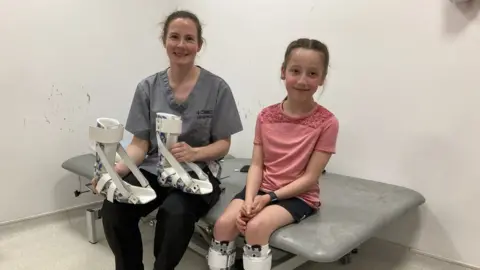 Imogen and orthotist Noelle fitting splints