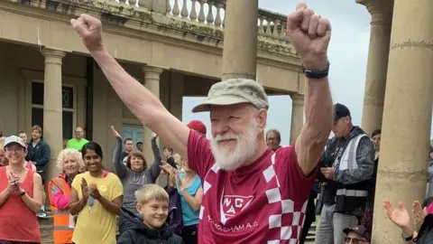 Mary Anderson Rodney Freeburn cheering at the start of Norwich Parkrun