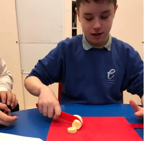 East Park School Josh chops a banana