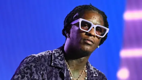Getty Images Rapper Young Thug speaks onstage at the 2021 REVOLT Summit at 787 Windsor on November 13, 2021 in Atlanta