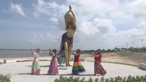 AFP Dancers celebrate at the unveiling of the new Shakira statue in Barranquilla on 26 December