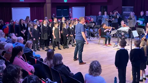 BBC School children and musicians performing for their parents