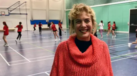 Bethan, a mum of three, looks at the camera