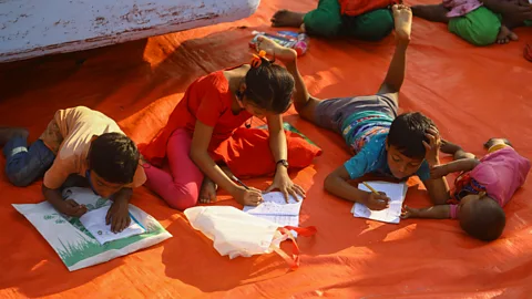 Anadolu Agency via Getty Images With the right support, children can learn to read in a wide range of settings, like this open-air school in Dhaka, Bangladesh (Credit: Anadolu Agency via Getty Images)