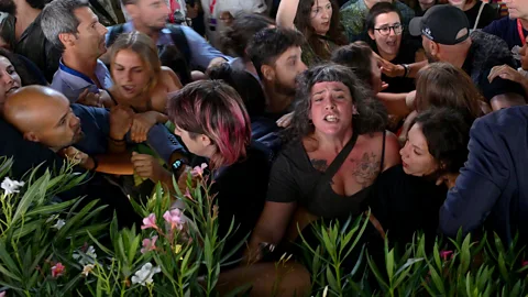 EPA A scuffle broke out amid protests at the Venice premiere for Woody Allen's latest film, Coup de Chance (Credit: EPA)
