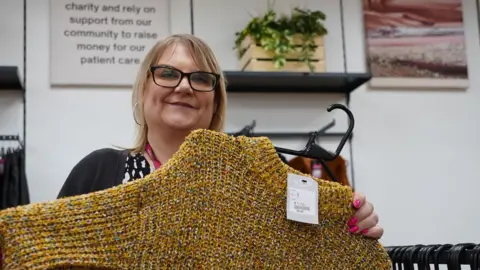 BBC Emma Hawnt holding a yellow jumper