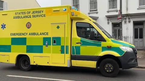 BBC Ambulance driving on a road in Jersey