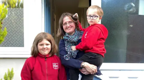 BBC Kidderminster mother of two Helen James poses for a photo outside her house with her two children: Lillian, 9, and Philip, 5.