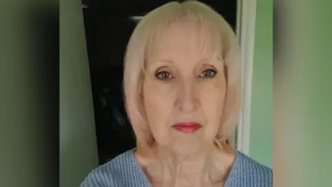 Wendy Isaacs Wendy Isaacs. She has short blonde hair and is wearing a blue jumper. She is looking directly at the camera and smiling.