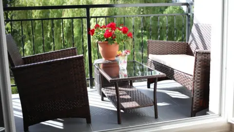 Antonio Salvani Shot of two chairs and table on a flat balcony