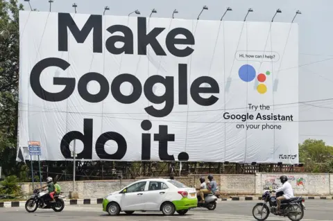 Getty Images Indian commuters drive past an advertisement poster of Google in Bangalore on 6 April 2018.
