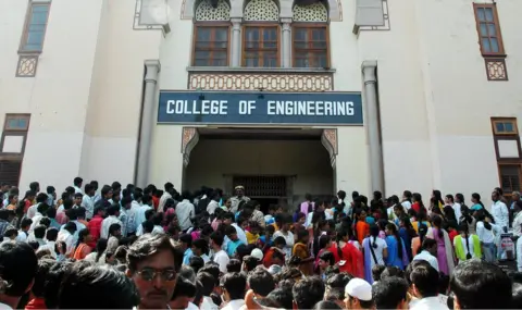 Getty Images Indian students wait outside an engineering college in Hyderabad.