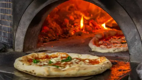 Getty Images Pizzas in oven