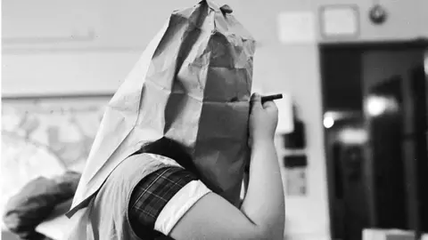 Hulton Archive/Getty Images Girl making Halloween mask