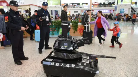 Getty Images A police robot tank patrols the waiting hall on the first day of the Spring Festival travel rush at the Shenzhen North Railway Station on January 21, 2019 in Shenzhen, Guangdong Province of China.