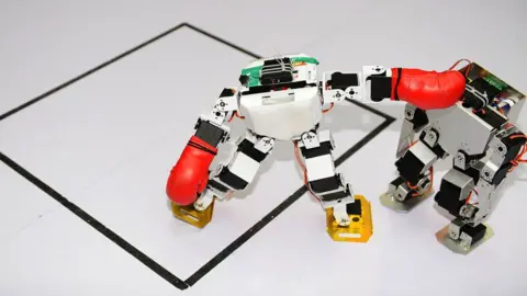 Getty Images Two robots fight in a humanoid fighting competition during the 2016 China RoboWork Competition International Open at Rizhao Campus of Shandong Sport University on May 28, 2016 in Rizhao, Shandong Province of China.
