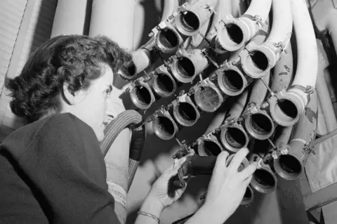 Getty Images The 1955 pneumatic tube system in use in the New York office of financial company Merrill Lynch, Pierce, Fenner & Beane