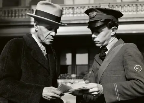 Getty Images A Western Union messenger delivering a telegram, circa 1900.