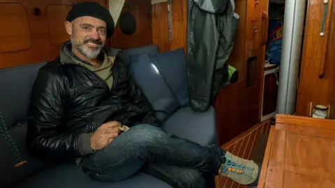 AFP Argentine sailor Juan Manuel Ballestero poses for a picture in the cabin of his sailboat