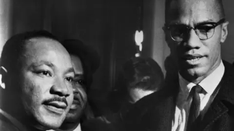 Getty Images The brief, and only, meeting between Malcolm X (R) and Martin Luther King (L) in Washingon DC, 26 March 1964
