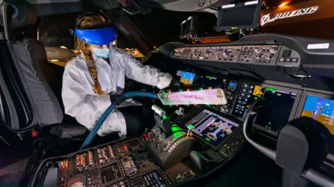 Boeing A worker using Boeing's 'UV wand'