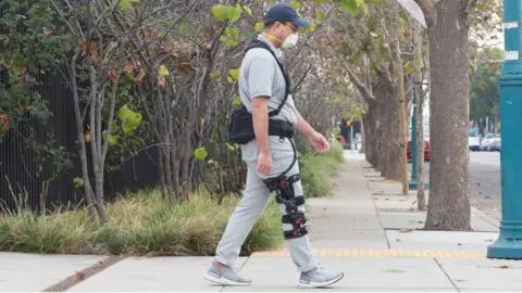 SuitX A man wearing a SuitX BoostX knee brace
