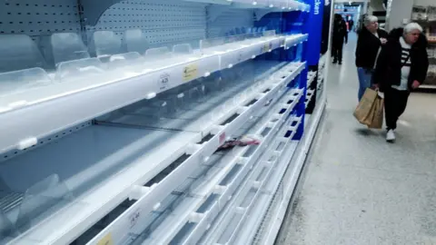 Getty Images Empty shelves in a Sainsbury's supermarket in London in March 2020