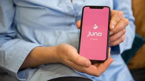 Juno A woman holding the Juno app