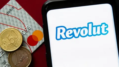 Getty Images Revolut logo with euro coins and banking card
