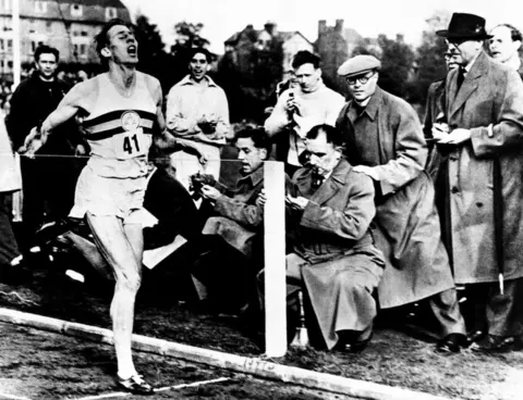PA Media Roger Bannister finishing the race during an athletics meeting at Oxford where he ran the world's first four-minute mile