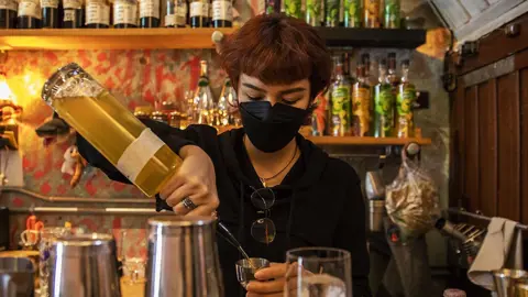 Getty Images Woman preparing cocktails