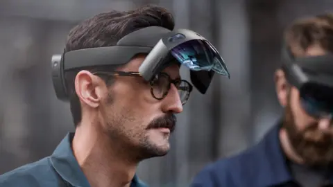 Chris Hornbecker Two men wearing HoloLens 2 headsets