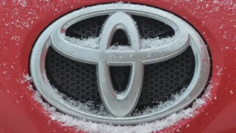 Getty Images Toyota logo seen on a Toyota car covered with snow.