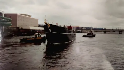 Paul Simpson Discovery being towed up the River Tay in 1992