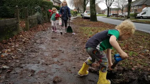 YGC Rebel Mams child sweeping leaves