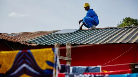 Zola Energy A Zola worker in Rwanda