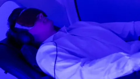 Justin Brantley A man lies while receiving neurofeedback therapy.