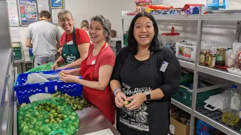 Caring in Bristol Caring in Bristol volunteers helping with the preparation and cooking of Christmas dinner for guests
