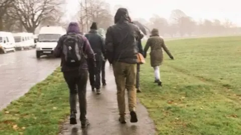Rachel Rayner A group of walkers in the rain