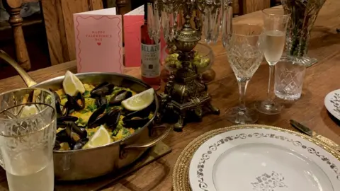 BBC/Jess Warren A dinner table with full wine glasses and champagne flutes
