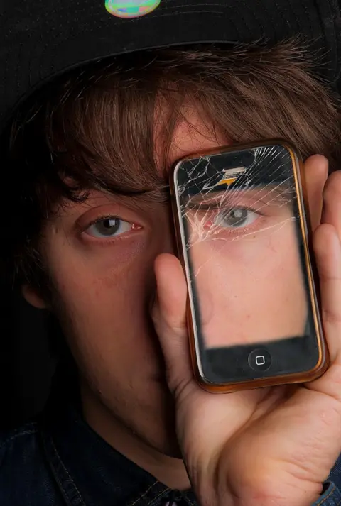 Lee Morley Person holding mobile phone in front of their face
