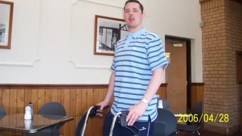 Colin Robertson Colin with his "zoomer" walking frame years after his stroke