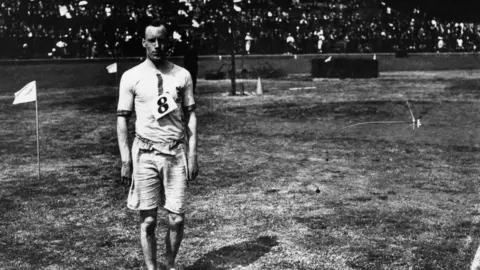 Topical Press Agency 1924: Eric Liddell (1902 - 1945), winner of the 100 yards flat at the AAA Championships at Stamford Bridge, London. He was known as the 'Flying Scotsman'.