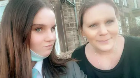 Family handout A selfie of Holly and her mother. Holly has long brown hair and Micala has blond hair, both are looking at the camera smiling.