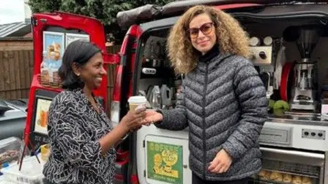 BBC Inthu Rajah receiving a cup of coffee