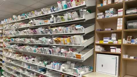 BBC/Gemma Dillon Stocks of medication at a pharmacy in Leeds.