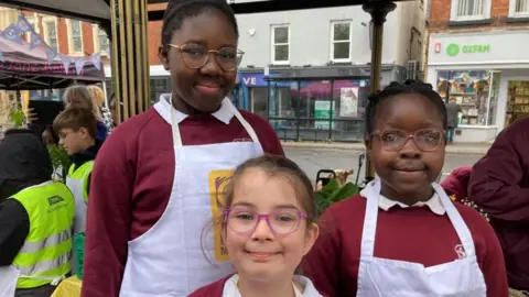 Alex Pope/BBC Three children from Cauldwell School, Bedford, at Bedford Market