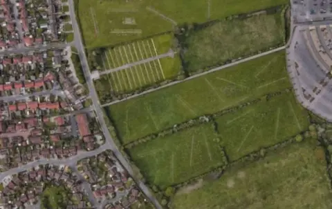 Together Housing The green space where the new houses are being planned, with other houses pictured nearby